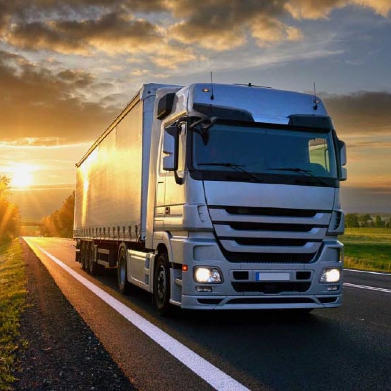 Road Transport Truck Driving at Sunset - Less CO2 for Climate Protection